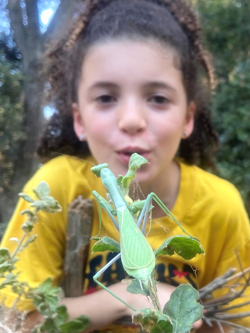 child drinking from hydration pack on hike