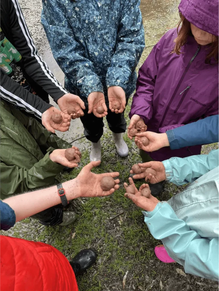 kids holding rocks teamwork outdoor activity